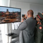 Foreign delegates watching video on the 3D display at the UralVagonZavod pavilion at RAE-2013